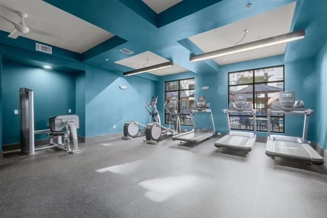 Gym with treadmills and elliptical machines fitness room at Signature 1505 in Raleigh Student Accommodation