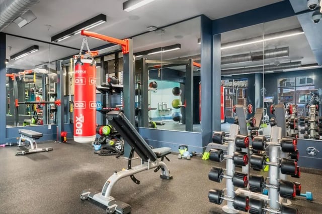 Dumbbells boxing bag and bench Gym playing area at Signature 1505 in Raleigh Student Accommodation