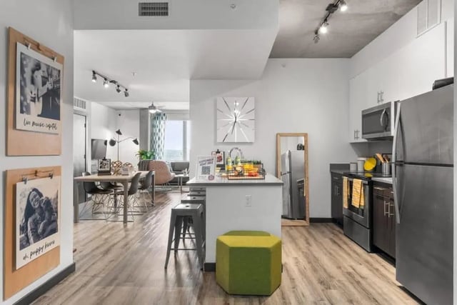 Kitchen island, stools, table, chairs, living area kitchen interior at Signature 1909 in Austin Student Accommodation
