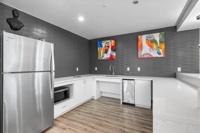 Stainless steel fridge microwave sink and artworks kitchen at Signature 1909 in Austin Student Accommodation