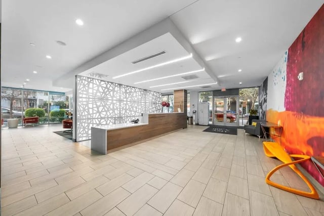 Reception desk patterned screen seating area lobby at Signature 1909 in Austin Student Accommodation