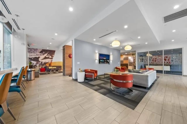 Modern lounge with couches chairs and television living room at Signature 1909 in Austin Student Accommodation