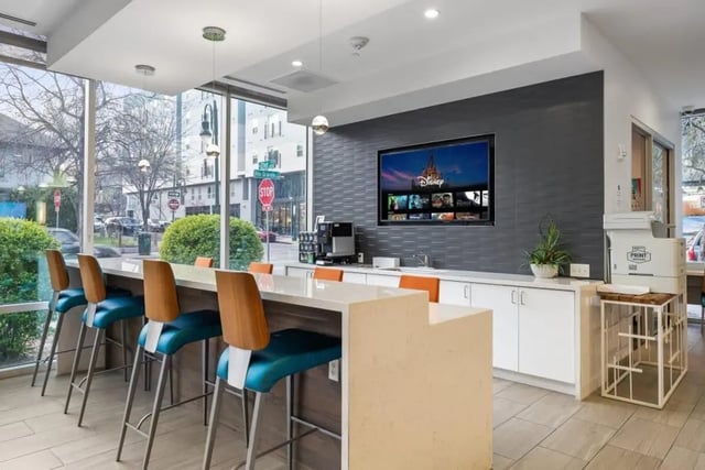 Bar stools, counter, TV, printer, communal area at Signature 1909 in Austin Student Accommodation