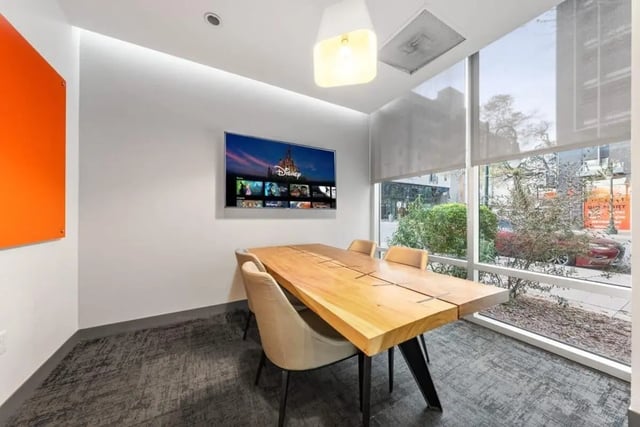 Table chairs television wall art study area at Signature 1909 in Austin Student Accommodation