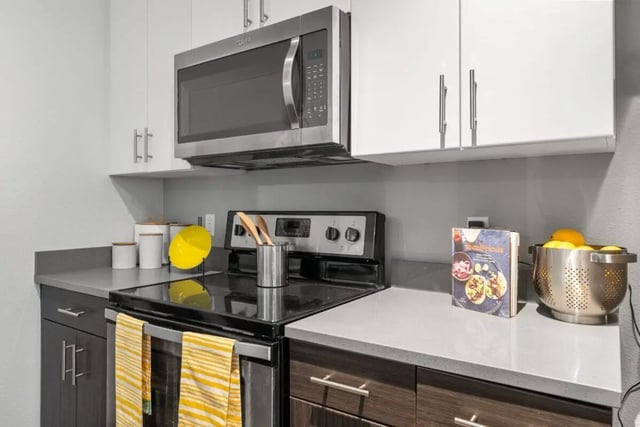 Microwave stove cookware and fruit colander kitchen at Signature 1909 in Austin Student Accommodation