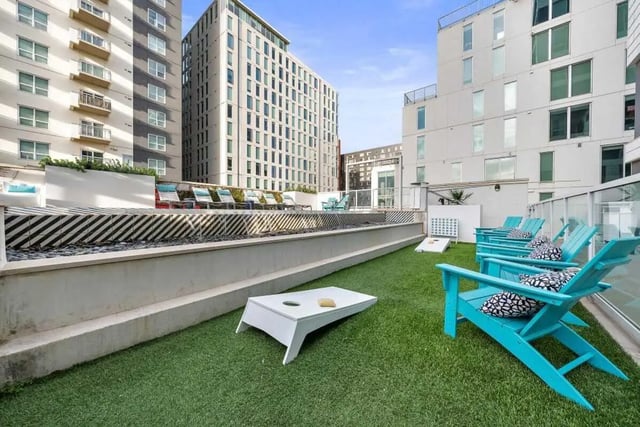 Aqua Adirondack chairs and cornhole set patio at Signature 1909 in Austin Student Accommodation