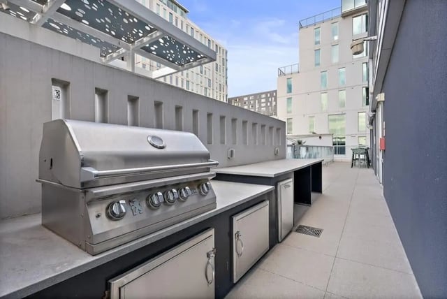 Built-in grill and outdoor kitchen counter exterior at Signature 1909 in Austin Student Accommodation