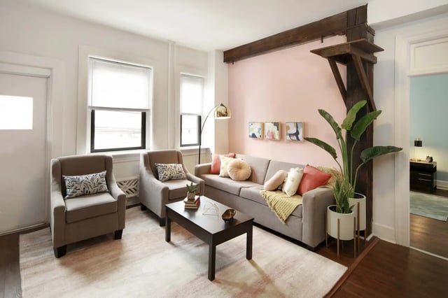 Sofa armchairs coffee table and plant living room at Hamilton Court in Philadelphia Student Accommodation