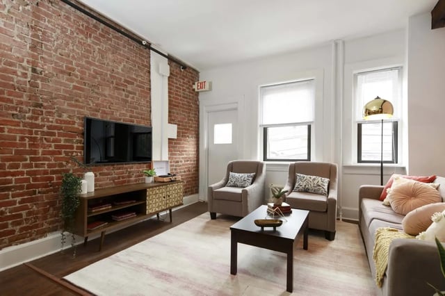 Sofa two chairs coffee table television living room at Hamilton Court in Philadelphia Student Accommodation