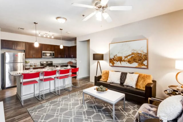 Kitchen island seating with living area furniture living room at Stadium View in Bozeman Student Accommodation