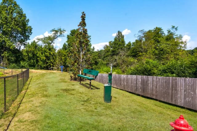 Green bench with trash station exterior at Stadium View in Bozeman Student Accommodation