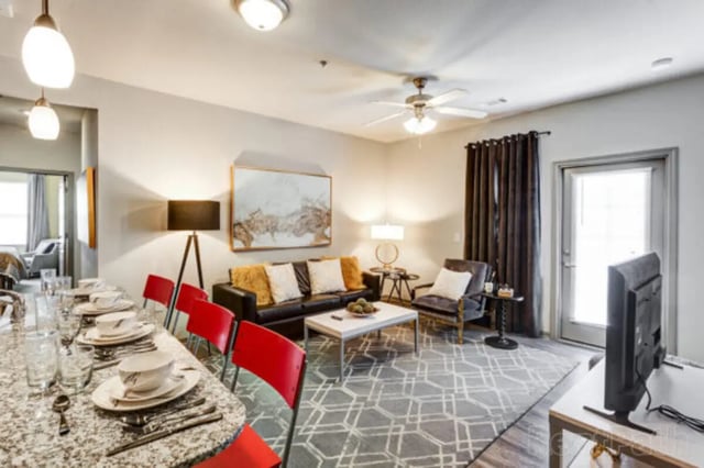 Dining table sofa chairs painting television living room at Stadium View in Bozeman Student Accommodation