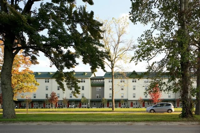 Apartment building with green roof and windows Exterior at Hannah Townhomes & Lofts in East Lansing Student Accommodation