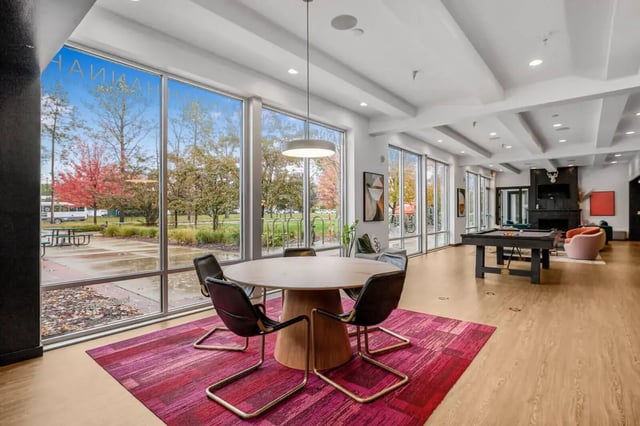 Round table with chairs billiard table living room at Hannah Townhomes & Lofts in East Lansing Student Accommodation