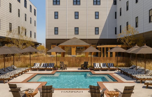 Pool lounge chairs umbrellas wooden gazebo courtyard outdoor area at Hannah Townhomes & Lofts in East Lansing Student Accommodation