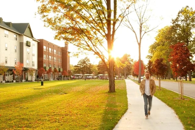 Student dorms with grass and a walking path Exterior at Hannah Townhomes & Lofts in East Lansing Student Accommodation