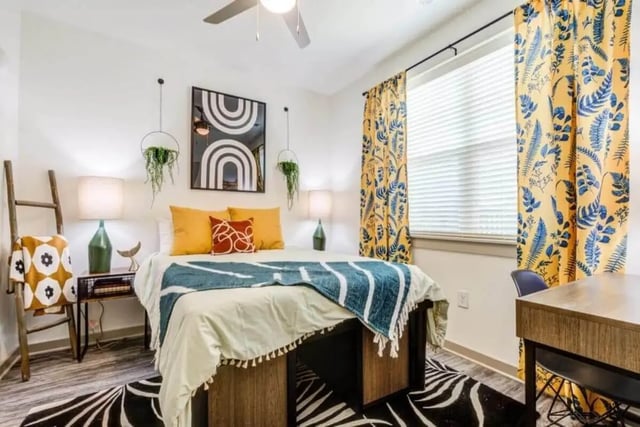 Bed bedside table artwork yellow curtains desk bedroom at Signature Hartwell Village in Seneca Student Accommodation