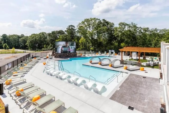 Pool with lounge chairs outdoor screen and seating exterior at Signature Hartwell Village in Seneca Student Accommodation