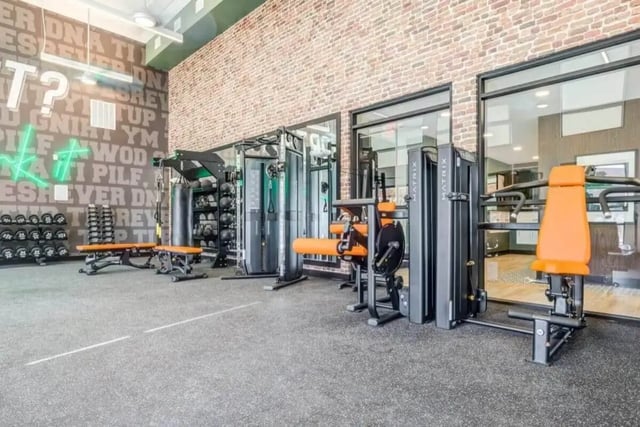 Weight racks punch bag and exercise machines fitness area at Signature Hartwell Village in Seneca Student Accommodation