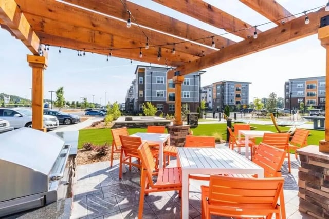 Outdoor seating area with grill and buildings exterior at Signature Hartwell Village in Seneca Student Accommodation