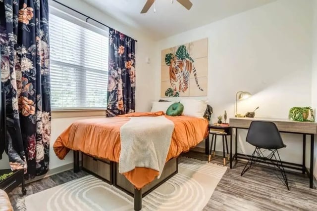 Bed with orange bedding and desk area bedroom at Signature Hartwell Village in Seneca Student Accommodation