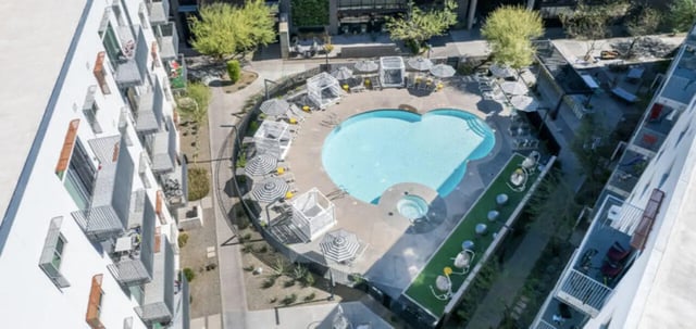 Resort style pool with cabanas and loungers exterior at Vertex Apartments in Tempe Student Accommodation