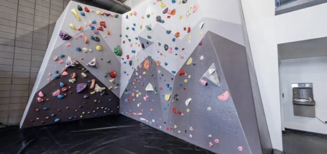 Climbing walls with colorful holds recreation area at Vertex Apartments in Tempe Student Accommodation