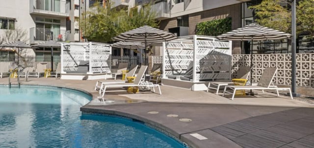 Poolside loungers cabanas and umbrellas playing area at Vertex Apartments in Tempe Student Accommodation