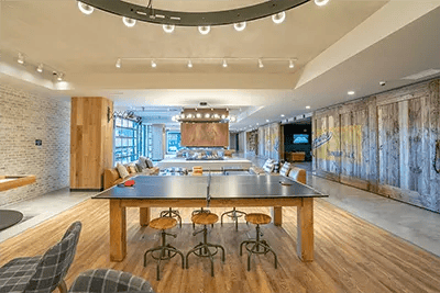 Ping pong table stools fireplace seating area lounge at Landmark on Grand River in East Lansing Student Accommodation
