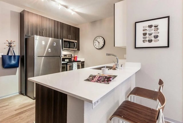 Modern kitchen with stainless steel appliances and seating kitchen at Muse on Main in Pullman Student Accommodation