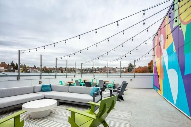 Lounge seating tables chairs string lights exterior at Muse on Main in Pullman Student Accommodation