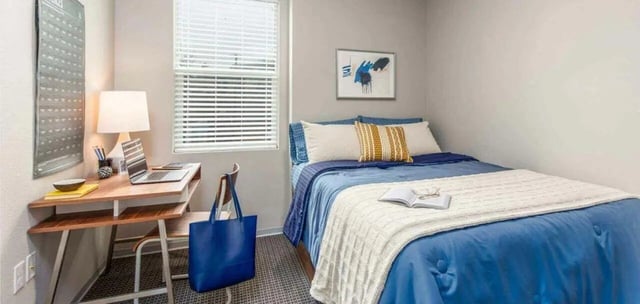 Desk with laptop bed and artwork bedroom at Muse on Main in Pullman Student Accommodation