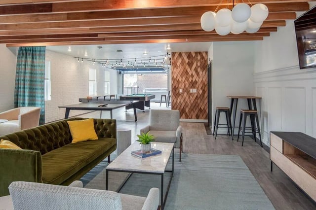 Living area with sofa ping pong table and pool table at Muse on Main in Pullman Student Accommodation