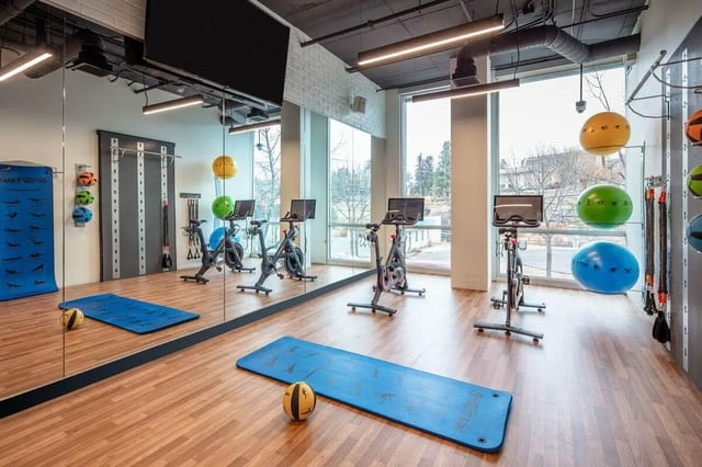 Spin bikes yoga mats medicine balls fitness room at Muse on Main in Pullman Student Accommodation