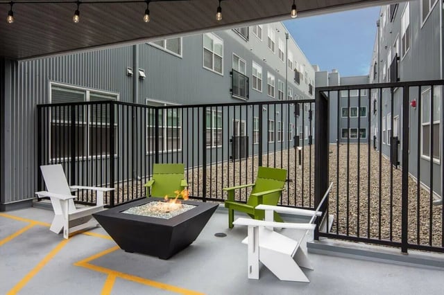 Fire pit chairs and modern building exterior outdoor area at Muse on Main in Pullman Student Accommodation