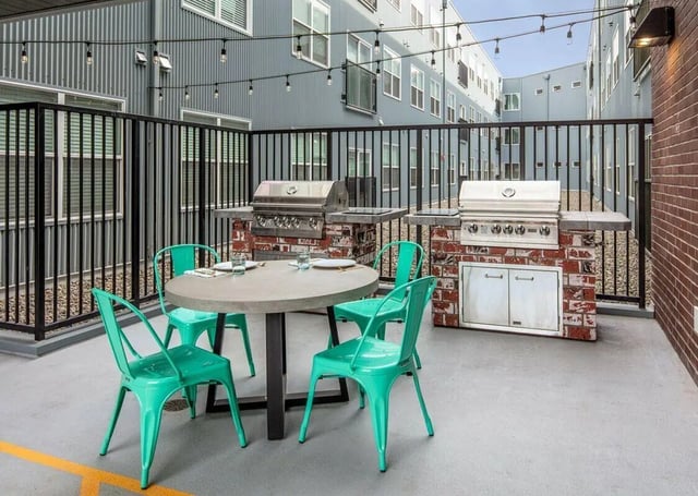 Grills and chairs at outdoor seating area at Muse on Main in Pullman Student Accommodation