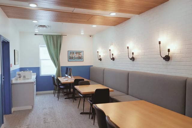Study tables with computers and sofa seating study area at Muse on Main in Pullman Student Accommodation