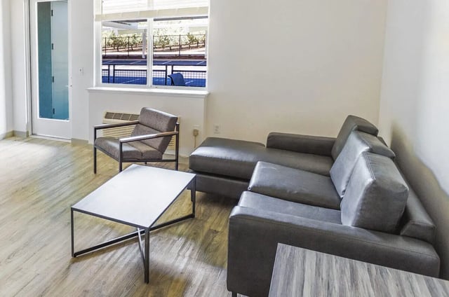 Sofa chairs coffee table living room at Merced Station in Merced Student Accommodation