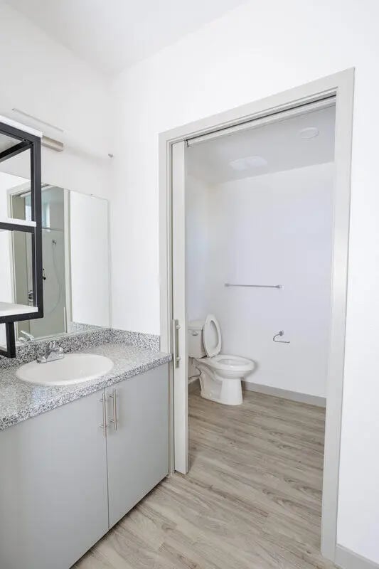 Sink vanity toilet and shower area bathroom at Merced Station in Merced Student Accommodation