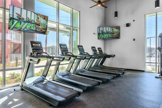 Treadmills with large screens gym area at Merced Station in Merced Student Accommodation