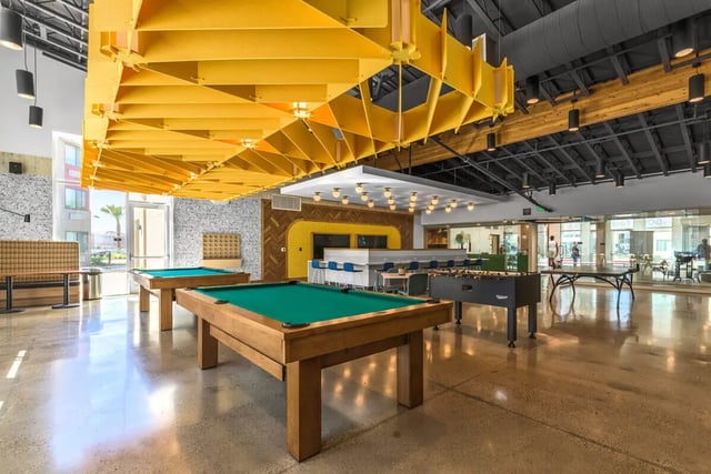 Pool tables foosball table and bar area lounge at Merced Station in Merced Student Accommodation