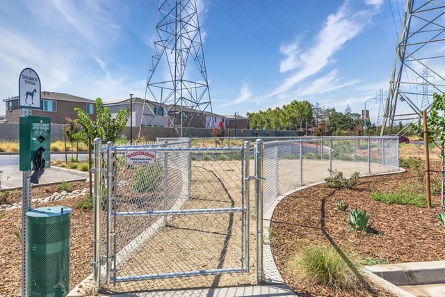 Dog waste station and fenced dog area exterior at Merced Station in Merced Student Accommodation