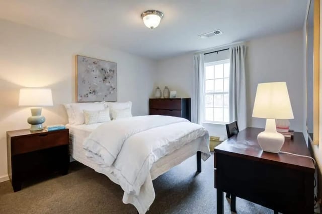 Bed nightstand painting desk lamp bedroom at Mustang Village in Wichita Falls Student Accommodation