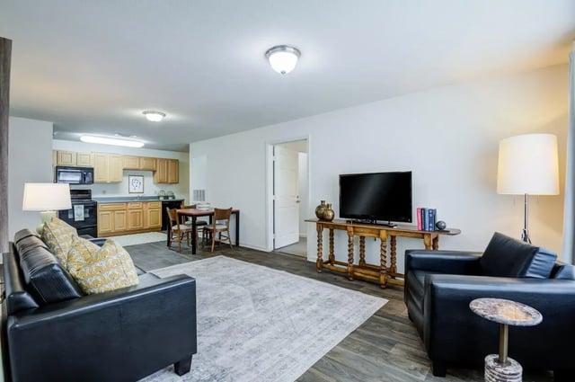 Sofa kitchen table and TV living room at Mustang Village in Wichita Falls Student Accommodation