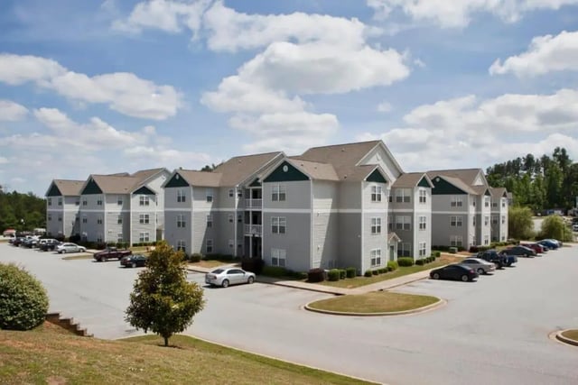 Apartment buildings with cars and landscaping exterior at University Village At Clemson in Central Student Accommodation