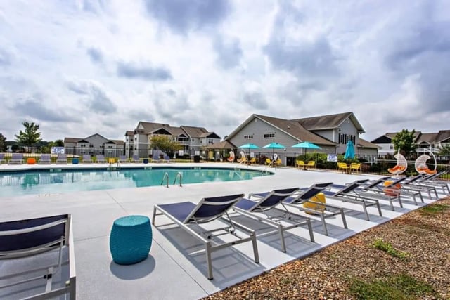 Pool lounge chairs and hanging chairs exterior at University Village At Clemson in Central Student Accommodation
