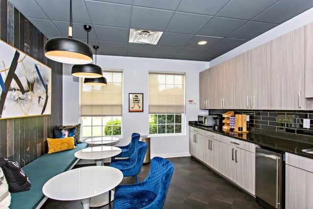 Blue chairs white tables long bench kitchen communal area at University Village At Clemson in Central Student Accommodation