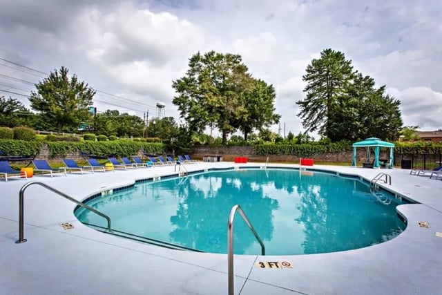 Pool with lounge chairs and canopy. Playing area. at University Village At Clemson in Central Student Accommodation