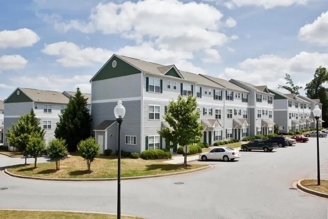 Townhouses with cars and trees exterior at University Village At Clemson in Central Student Accommodation
