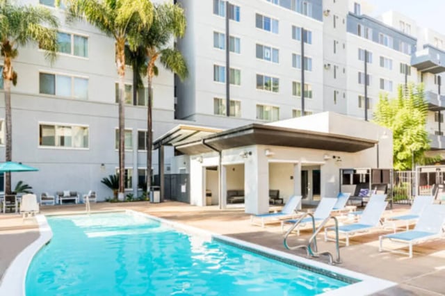 Pool lounge chairs and outdoor lounge area Exterior at University Village Towers in Riverside Student Accommodation
